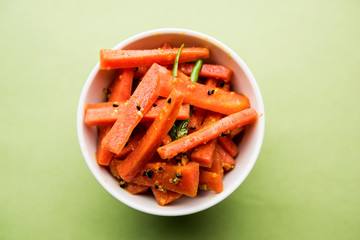 Carrot Pickle / Gajar ka Achar or Loncha in hindi. Served in a bowl over moody background....