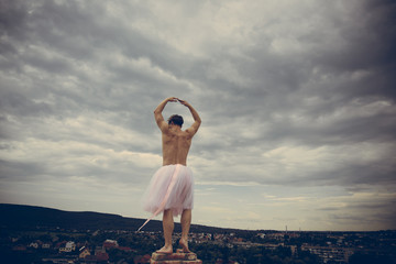 Crazy ballerina. drag queen. Funny man freak. Man dancing in tutu in ballet studio. Man in...