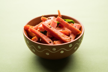 Carrot Pickle / Gajar ka Achar or Loncha in hindi. Served in a bowl over moody background....