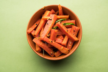 Carrot Pickle / Gajar ka Achar or Loncha in hindi. Served in a bowl over moody background....