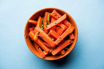 Carrot Pickle / Gajar ka Achar or Loncha in hindi. Served in a bowl over moody background....