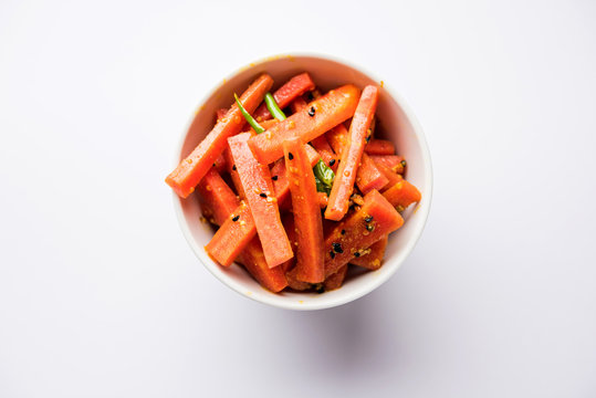 Carrot Pickle / Gajar ka Achar or Loncha in hindi. Served in a bowl over moody background. Selective focus