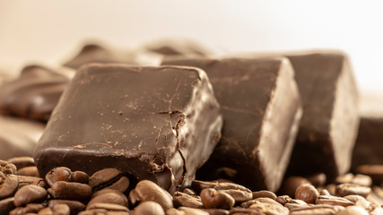 Chocolates and coffee seeds on wooden background