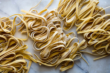 Close up of tagliatelle pasta against white background