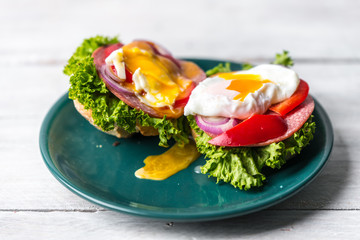 healthy and tasty sandwich with salami, peppers, purple onion, lettuce and poached egg