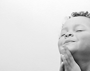 little boy praying with eyes closed stock photo