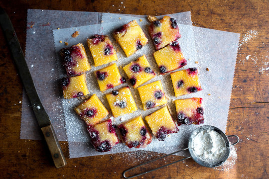 Close up of blueberry lemon bar on wooden table