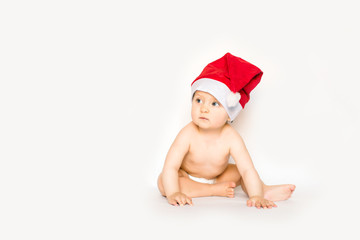 Adorable christmas child in a red hat isolated on white background
