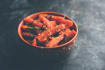 Carrot Pickle / Gajar ka Achar or Loncha in hindi. Served in a bowl over moody background....