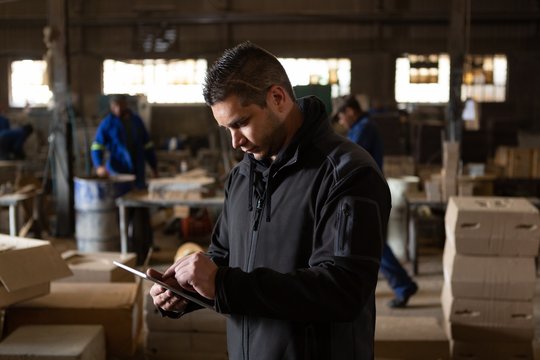 Man using digital tablet in foundry