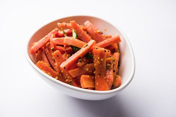 Carrot Pickle / Gajar ka Achar or Loncha in hindi. Served in a bowl over moody background....