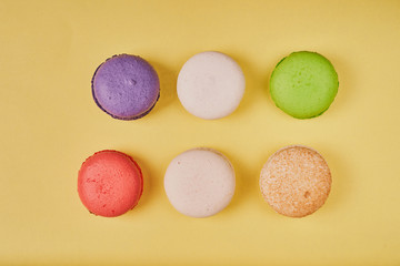 Cake macaron or macaroon on orange background. Top view