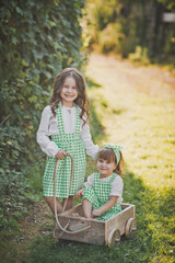 Two children play with a small cart 1876.