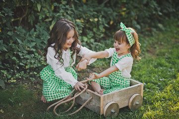 Children laugh and indulge in the street sitting in the cart 1879.