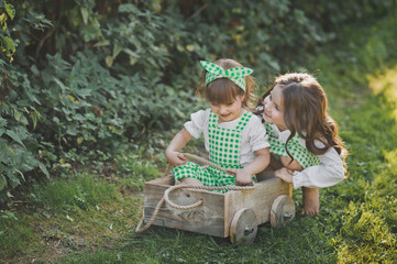 Children laugh and indulge in the street sitting in the cart 1880.