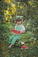 Smiling child with a piece of juicy watermelon in his hands 1900.