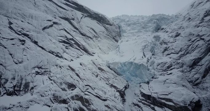 Flying towards blue Briksdalsbre glacier in Olden, Norway, Aerial shot