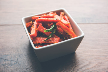 Carrot Pickle / Gajar ka Achar or Loncha in hindi. Served in a bowl over moody background....