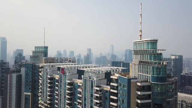 Guangzhou, China. Aerial revealing shot of congested building blocks and office building of Tianhe area on a sunny day in the afternoon.