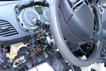 Fototapeta premium The dashboard of the car, the speedometer close-up.Repair of the car, disassembled the panel, the steering wheel.