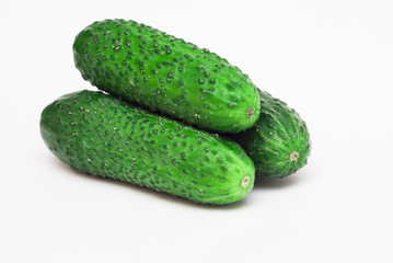 Three ripe green cucumber,closeup on white background.