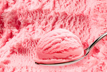 Strawberry  ice cream in spoon on ice cream background  