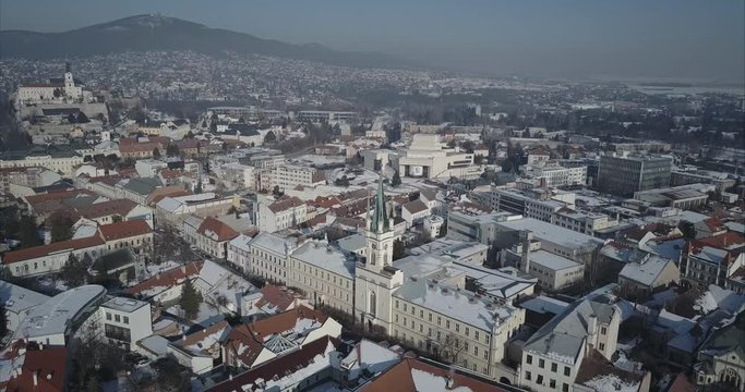 Wide aerial shot of Nitra town with Castle and mountains in background, Winter, Slovakia