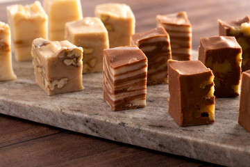 Six Different Flavors of Fudge on a Wooden Table