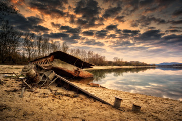 Rusty abandoned ship wreck in ship graveyard with dramatic effect