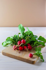 Bunch of radishes on a wooden board