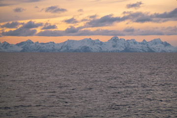 Fototapeta na wymiar boat view to stunning purple sunset during Norway winter time