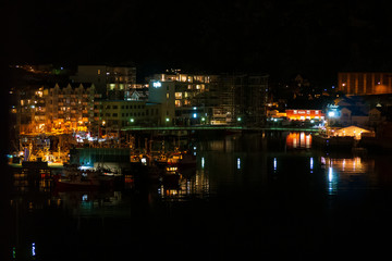 Fototapeta na wymiar Norway Coast City at Night with port water reflection