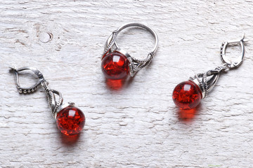 Jewelery from natural amber on a white wood texture background
