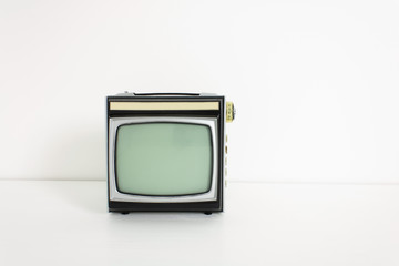 Obsolete retro TV receiver for analog television on white desk