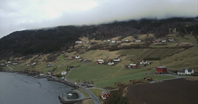Aerial shot of Cars passing through Utvik village, Cloudy, Norway