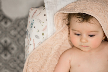 baby in towel after taking a bath