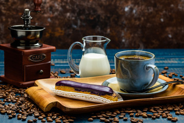 French coffee with cream and Eclair and coffee beans