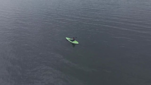 Men kayaking by himself in a lake all alone - water