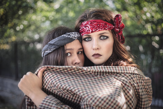 Portrait of two girls outdoors. The concept of difficult teenagers, bad students. Representatives of youth subcultures
