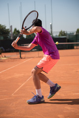 Young tennis player playing backhand