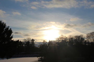 Fototapeta na wymiar Sunset in winter by frozen pond