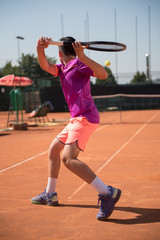 Young tennis player playing backhand