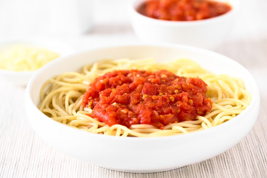 Traditional Italian Spaghetti alla Marinara (spaghetti with tomato sauce) in bowl, photographed with natural light (Selective Focus, Focus in the middle of the image)