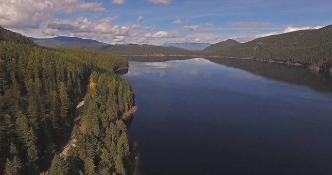 Aerial Drone Shot in Montana on a lake with a boat in the Fall or Autumn