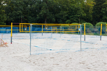 Venue with many Volleyball courts, a volleyball net on the beach.