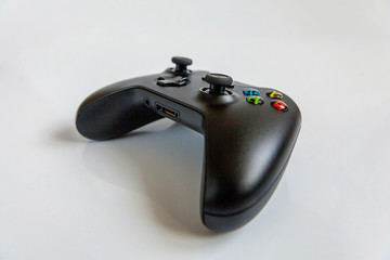Black joystick gamepad, game console isolated on white background. Computer gaming technology play...