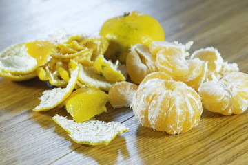 Tangerines and peel on the kitchen table. Close-up view.