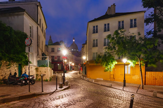 Empty street and the Sacre-Coeur at night, quarter Montmartre in Paris, France