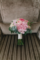 Wedding bouquet with pink and white peonies.