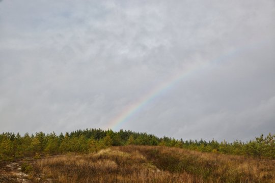 View of the surrounding hills and meadows in autumn, rainbow. © ALEKSANDR